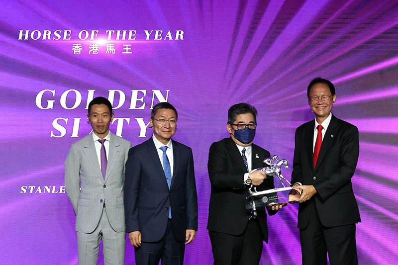 Golden Sixty is crowned Horse of the Year: Mr Philip Chen, Chairman of The Hong Kong Jockey Club, presents the trophy to owner Stanley Chan Ka Leung; the owner is accompanied by trainer Francis Lui and jockey Vincent Ho.