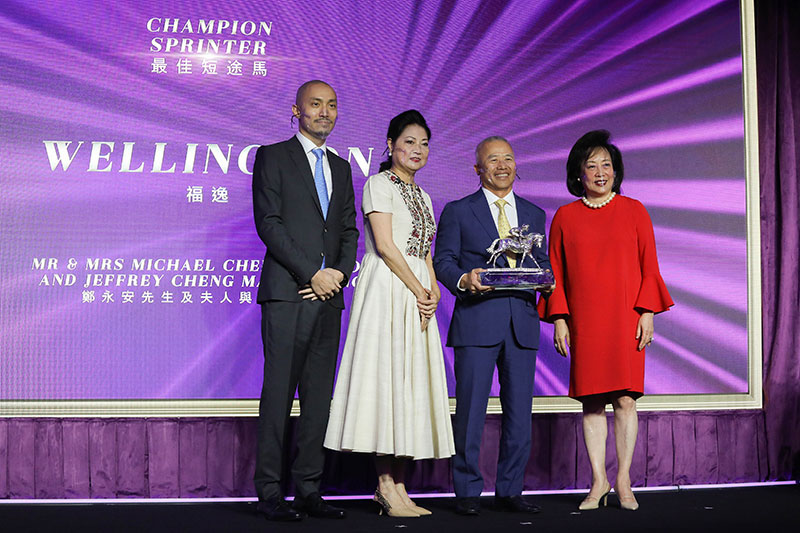 Dr Rosanna Wong, Steward of The Hong Kong Jockey Club, presents the Champion Sprinter trophy to Mr & Mrs Michael Cheng Wing On and Mr Jeffrey Cheng Man Cheong, owners of Wellington.