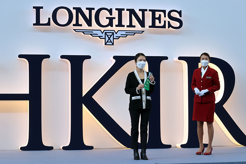 Ms Cecilia Kwok, Vice President from LONGINES Hong Kong and Macau, begins the barrier draw for the LONGINES Hong Kong Vase by picking the first horse name.