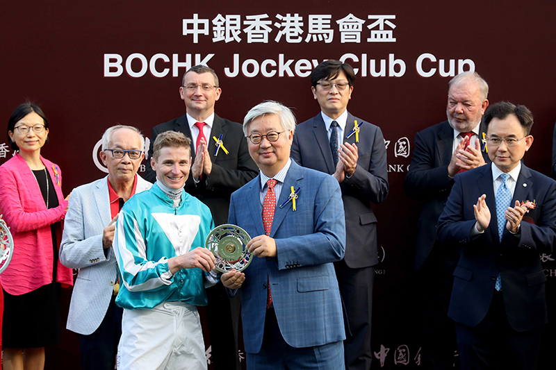HKJC Steward Dr Silas Yang presents the BOCHK Jockey Club Cup trophy and silver dishes to Romantic Warrior’s owner Peter Lau, trainer Danny Shum and jockey James McDonald.
