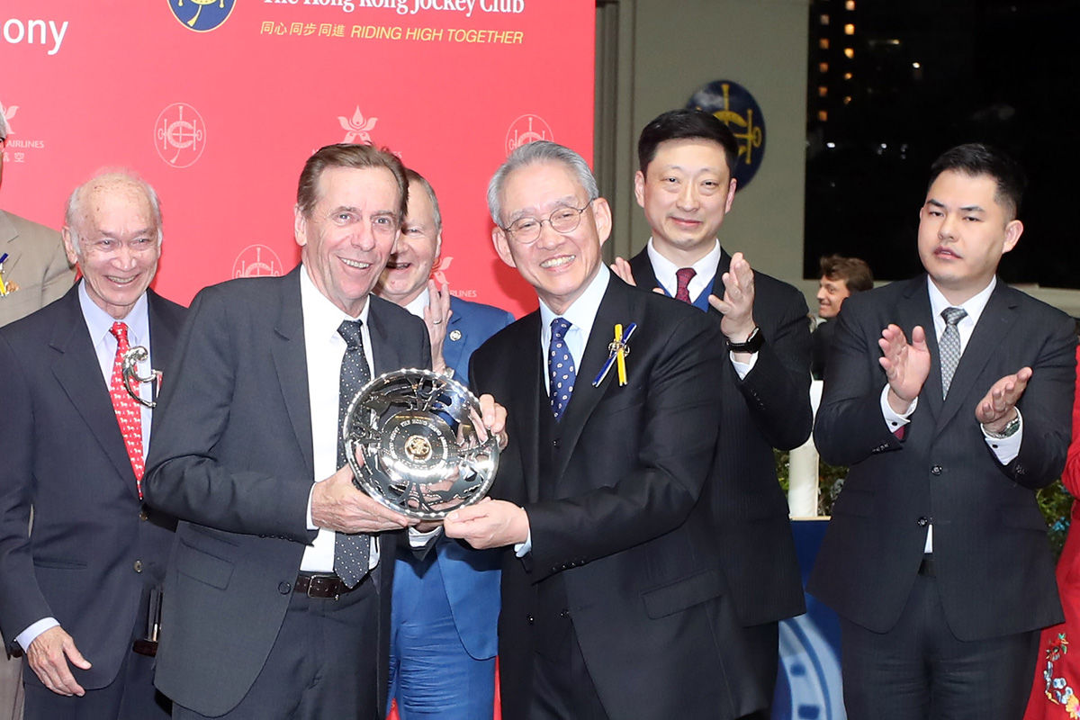 香港賽馬會主席周永健博士頒發銀碟予本年度香港航空百萬挑戰盃冠軍「鄉村瑰寶」的練馬師蔡約翰。