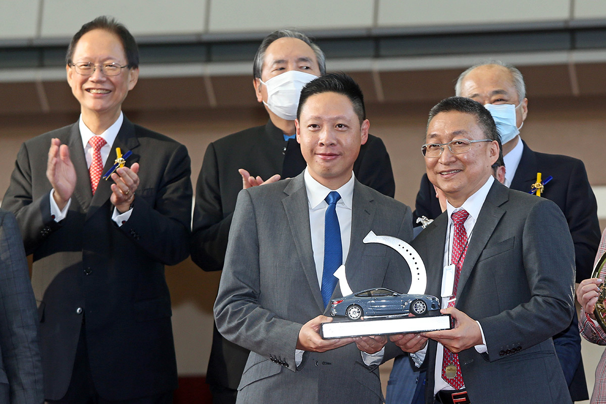 寶馬汽車（香港）有限公司香港及澳門董事總經理梁健燊頒發紀念品予「金鎗六十」的練馬師呂健威及騎師何澤堯。