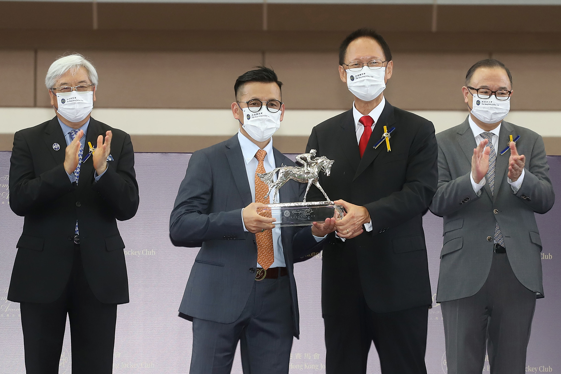 香港賽馬會主席陳南祿頒發冠軍練馬師獎座予羅富全。