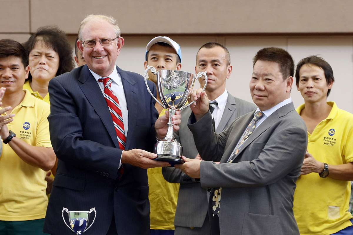 Trainer Manfred Man (right) receives the trophy for this season's Safest and Best Housekeeping Stable Award from Director of Racing Operations and Chairman of the Safety Committee (Racing Operations and Racing Development Board) John Ridley (left) at Sha Tin racecourse today.