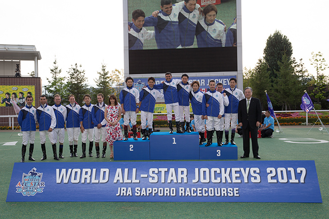 Moreira (2nd left) and other participating jockeys smile for the cameras at the World All-Star Jockeys series trophy presentation ceremony.