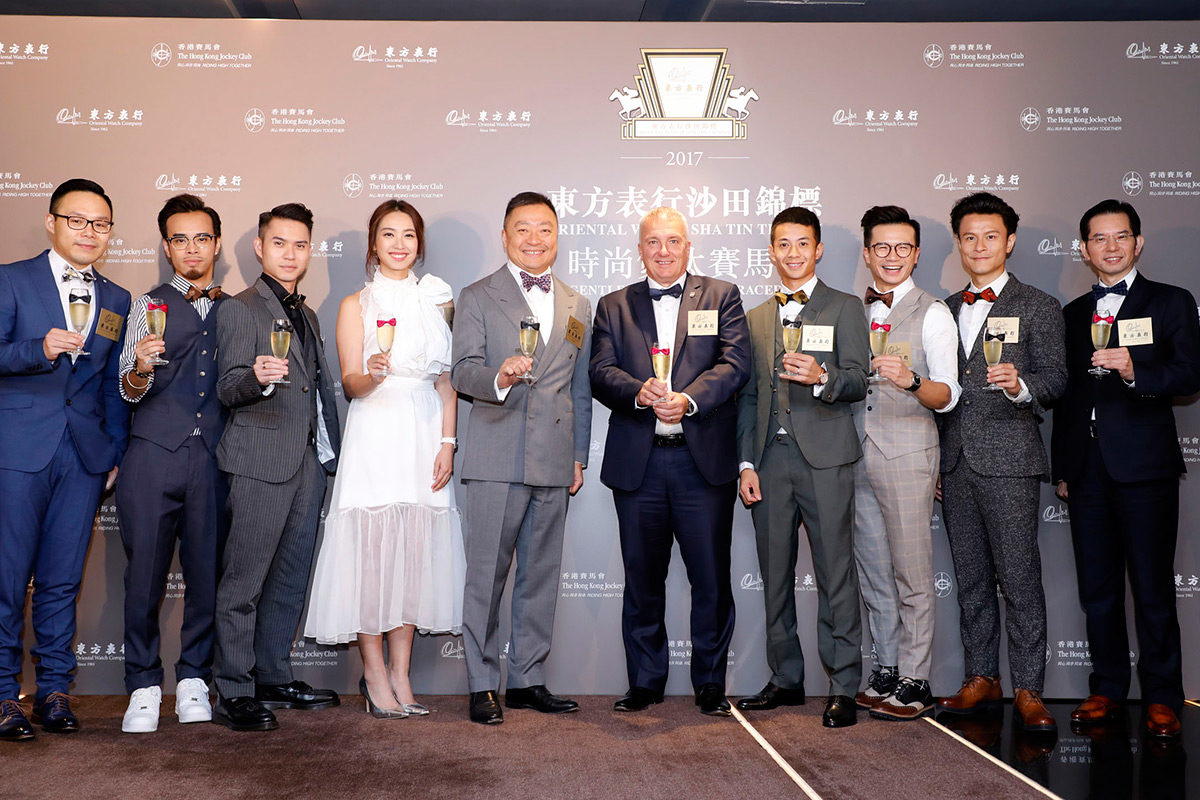 Officiating guests toast to the success of Oriental Watch Sha Tin Trophy “Gentlemen’s Bow Tie Day”. Mr. Anthony Kelly, Executive Director of Racing Business and Operations of The Hong Kong Jockey Club (5th from right), Mr. Dennis Yeung, Managing Director of Oriental Watch Holdings Limited (5th from left),Mr. Stanley Lam, General Manager of Oriental Watch Company Limited (right), Mr. Anthony Tsang, Marketing Manager of Oriental Watch Holdings Limited (left), Jockey Derek Leung (4th from right), Renowned actress Miss Tracy Chu (4th from left) and Cantopop group C AllStar (2nd and 3rd from left; 2nd and 3rd from right)