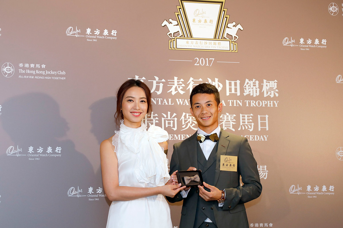 Miss Tracy Chu presents a mini bow tie to father-to-be Derek Leung.