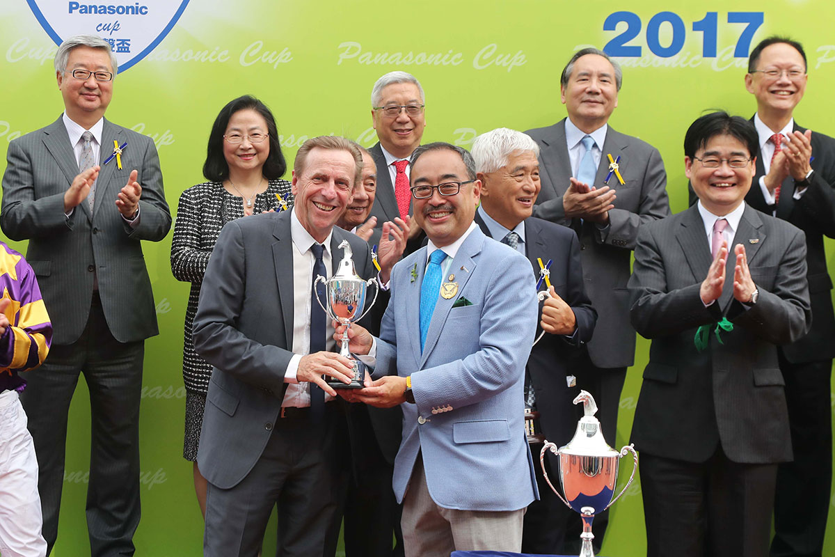 David Mong, Chairman & CEO of Shun Hing Group presents the trophy to winning trainer John Size.