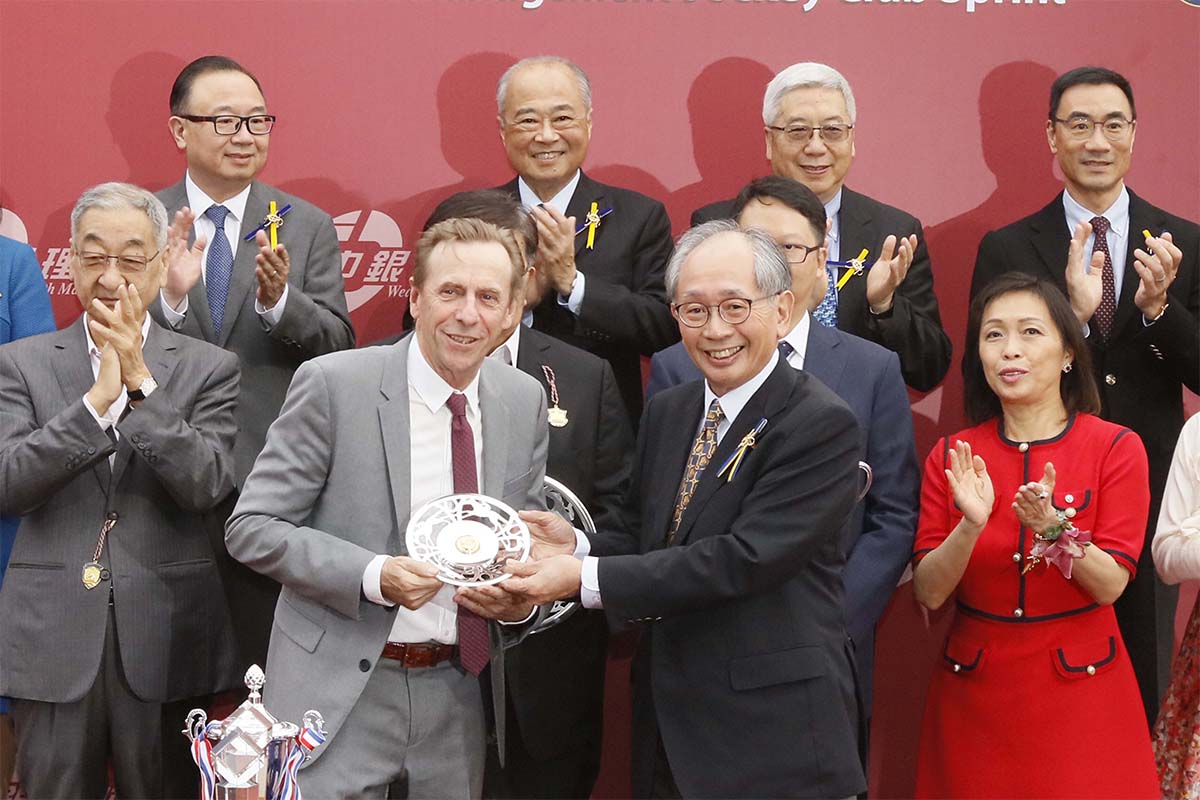 At the trophy presentation ceremony, Club Steward Mr Lester Kwok (right) presents the BOCHK Wealth Management Jockey Club Sprint trophy to the owner representative of race winner Mr Stunning, trainer John Size and jockey Nash Rawiller.