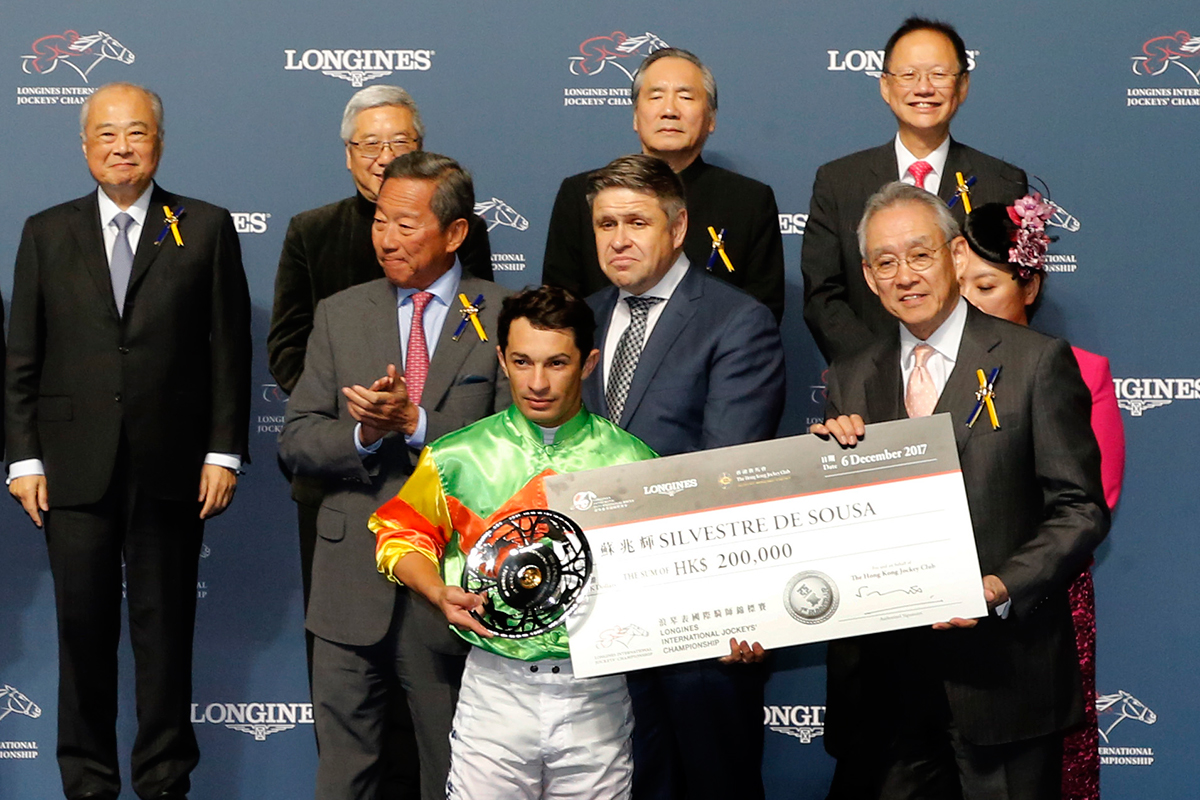 Mr Anthony W K Chow (right), Deputy Chairman of the HKJC, presents a silver dish and cash prize of HK$200,000 to Silvestre de Sousa, first runner-up of the LONGINES International Jockeys Championship.