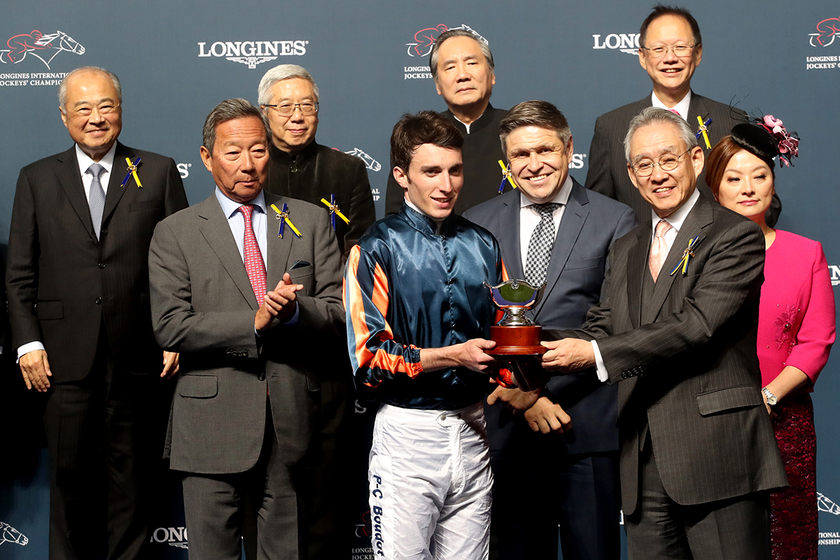 Mr Anthony W K Chow, Deputy Chairman of the HKJC, presents a silver bowl and cash prize of HK$100,000 to Pierre-Charles Boudot, second runner-up of the LONGINES International Jockeys Championship.