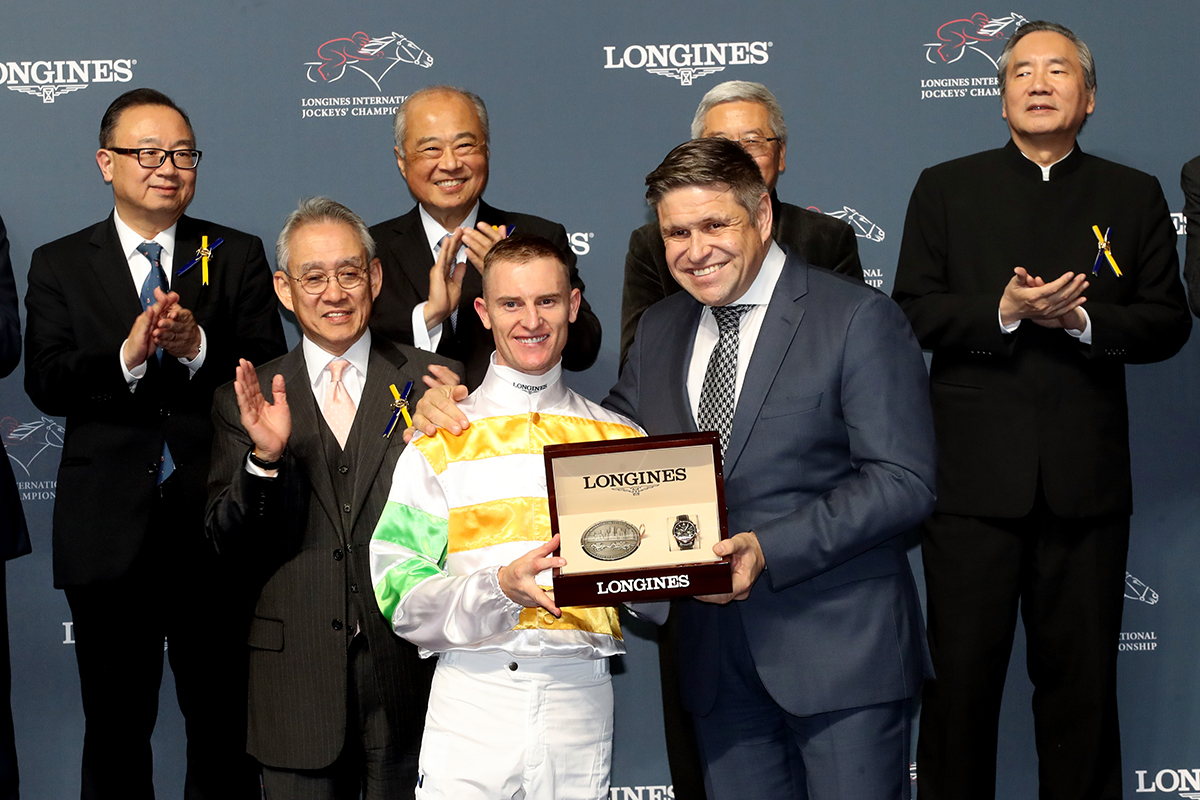 Mr Juan-Carlos Capelli (right), Vice President of LONGINES and Head of International Marketing, presents a LONGINES Conquest Classic Collection watch to Zac Purton, winner of the LONGINES International Jockeys Championship.