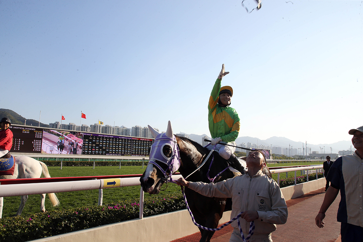 Jockey Keith Yeung throws his goggles to the crowd after winning the Class 2 Hong Kong Shipowners Association 60th Anniversary Cup Handicap on Classic Emperor.