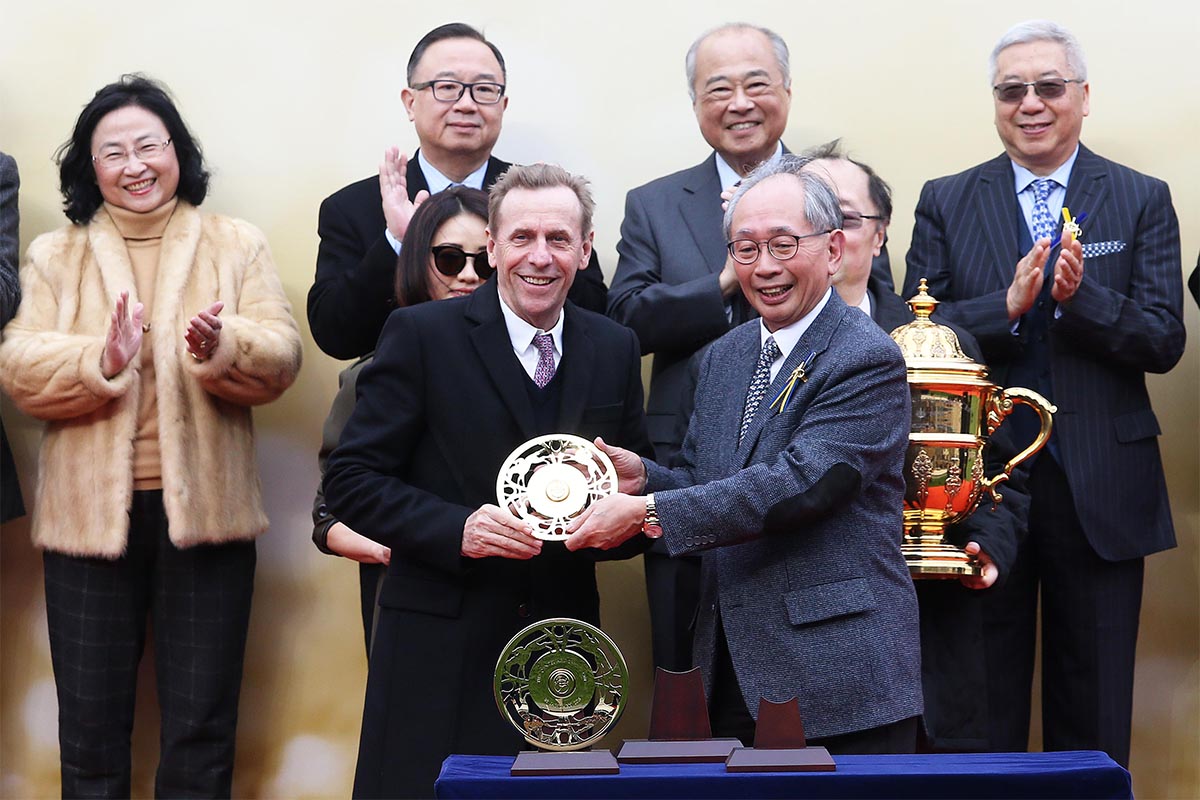 Lester C H Kwok, a Steward of The Hong Kong Jockey Club, presents the Centenary Sprint Cup winning trophy and the silver dishes to Samuel Wong Yin Shun, owner of winning horse D B Pin, winning trainer John Size and jockey Olivier Doleuze.