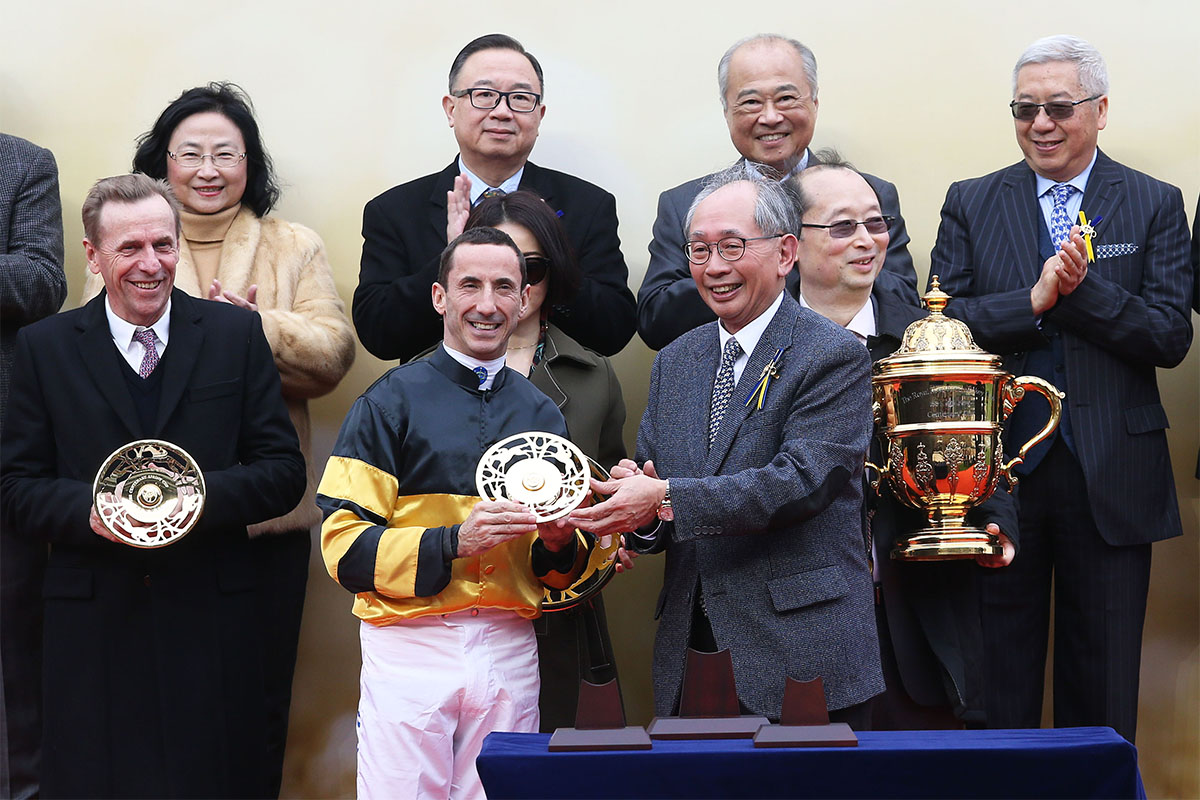 Lester C H Kwok, a Steward of The Hong Kong Jockey Club, presents the Centenary Sprint Cup winning trophy and the silver dishes to Samuel Wong Yin Shun, owner of winning horse D B Pin, winning trainer John Size and jockey Olivier Doleuze.