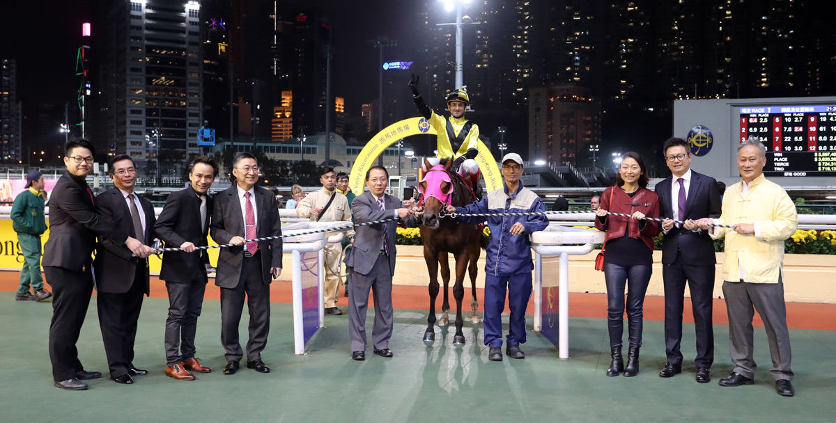 Happy connections of Born In China celebrate their runner’s victory in the winners’ circle.