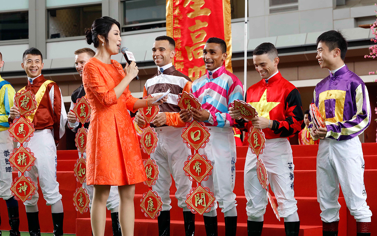 Jockeys greet fans at the opening ceremony and wish them good fortune and prosperity in the Year of the Dog.