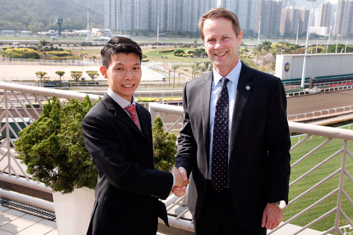Andrew Harding, HKJC’s Executive Director, Racing and Apprentice Jockey Victor Wong smile for the cameras.