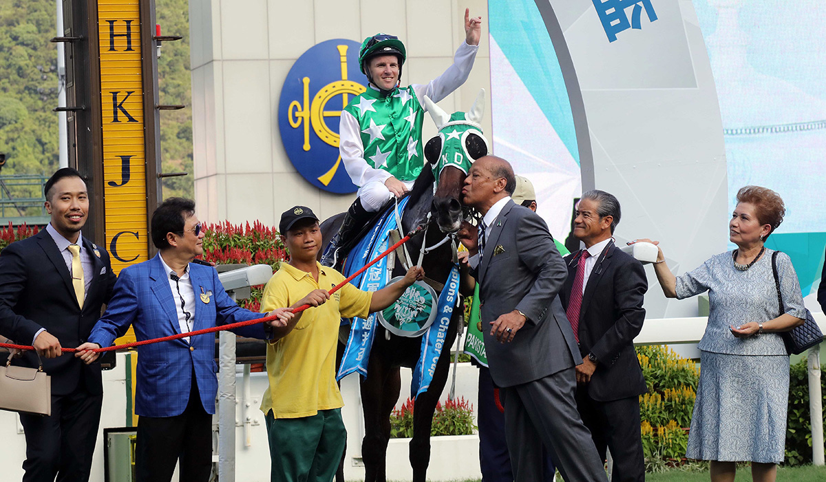 Connections of Pakistan Star celebrate their win after the race.