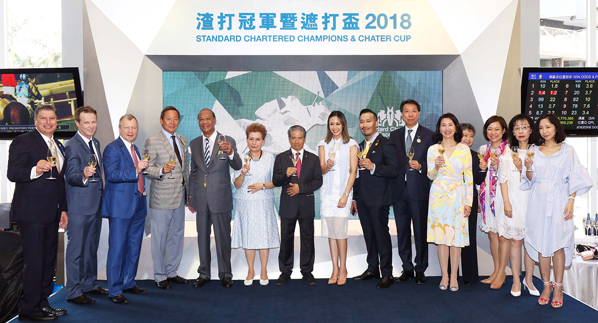 Representatives of The Hong Kong Jockey Club and The Standard Chartered Bank, together with the connections of winning horse Pakistan Star, toast the success of the Standard Chartered Champions & Chater Cup.
