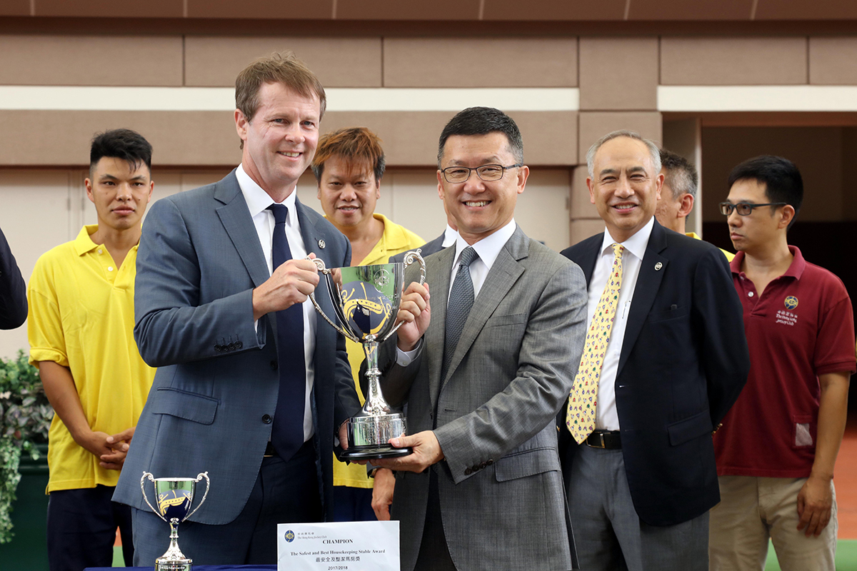 Trainer Peter Ho (right) receives the trophy for this season's Safest and Best Housekeeping Stable Award from Mr. Andrew Harding, the Club’s Executive Director, Racing (left) at Sha Tin racecourse today.