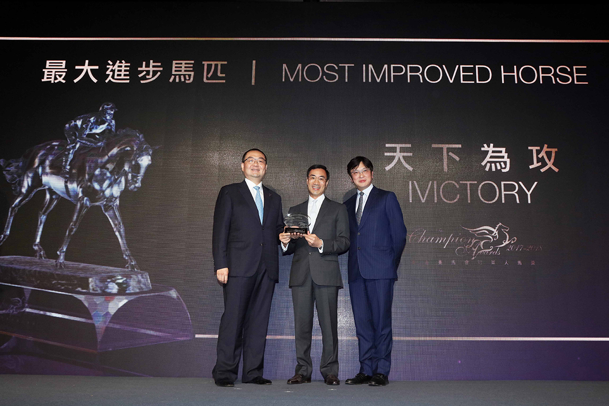 Mr. Benson Lo, President of the Hong Kong Racehorse Owners Association, presents the Most Improved Horse trophy to Michael T H Lee & Dr. Henry Chan Hin Lee, owners of Ivictory.