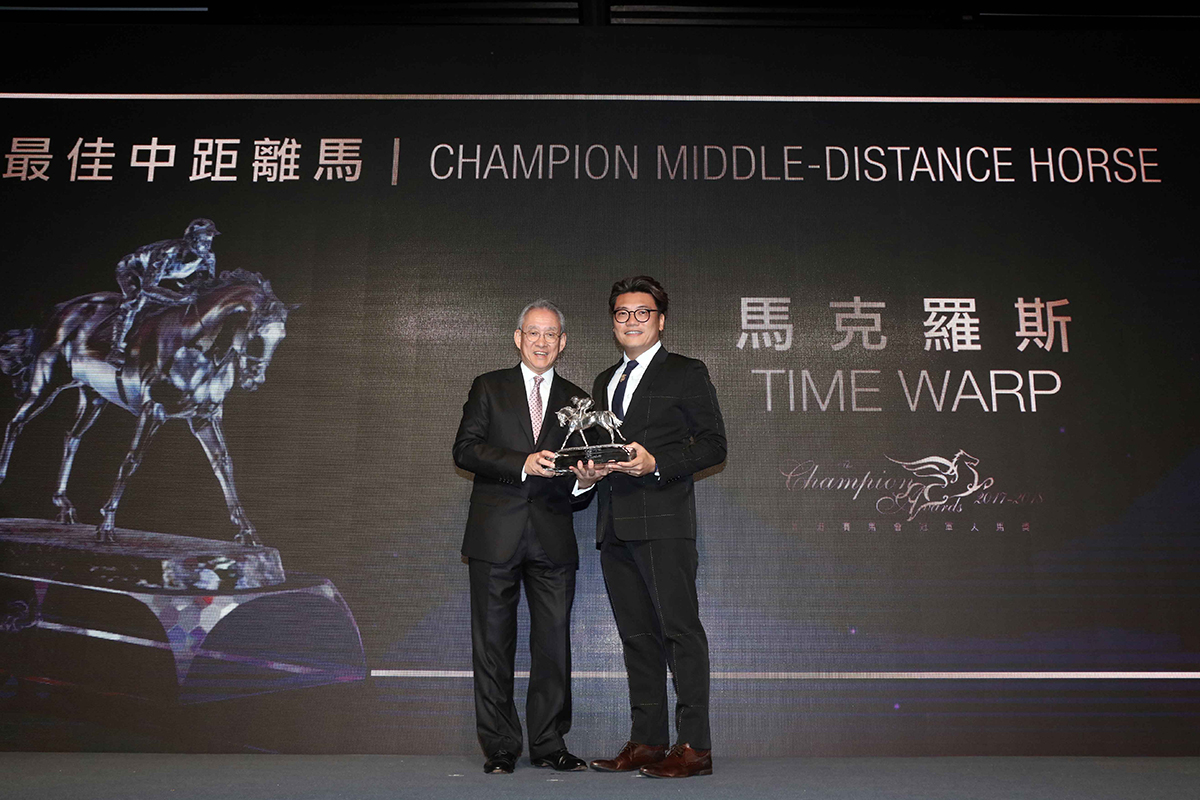 Mr. Anthony W K Chow, Deputy Chairman of HKJC, presents the Champion Middle-Distance Horse trophy to Mr. Martin Siu Kim Sun, owner of Time Warp.