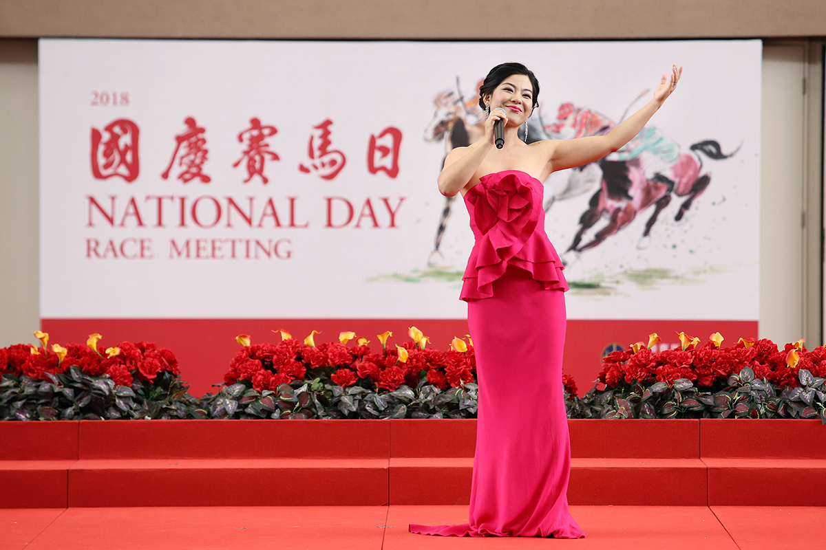 Cai Nan, a famous soprano from the China National Opera House, leads the national anthem accompanied by the Hong Kong Police Band.