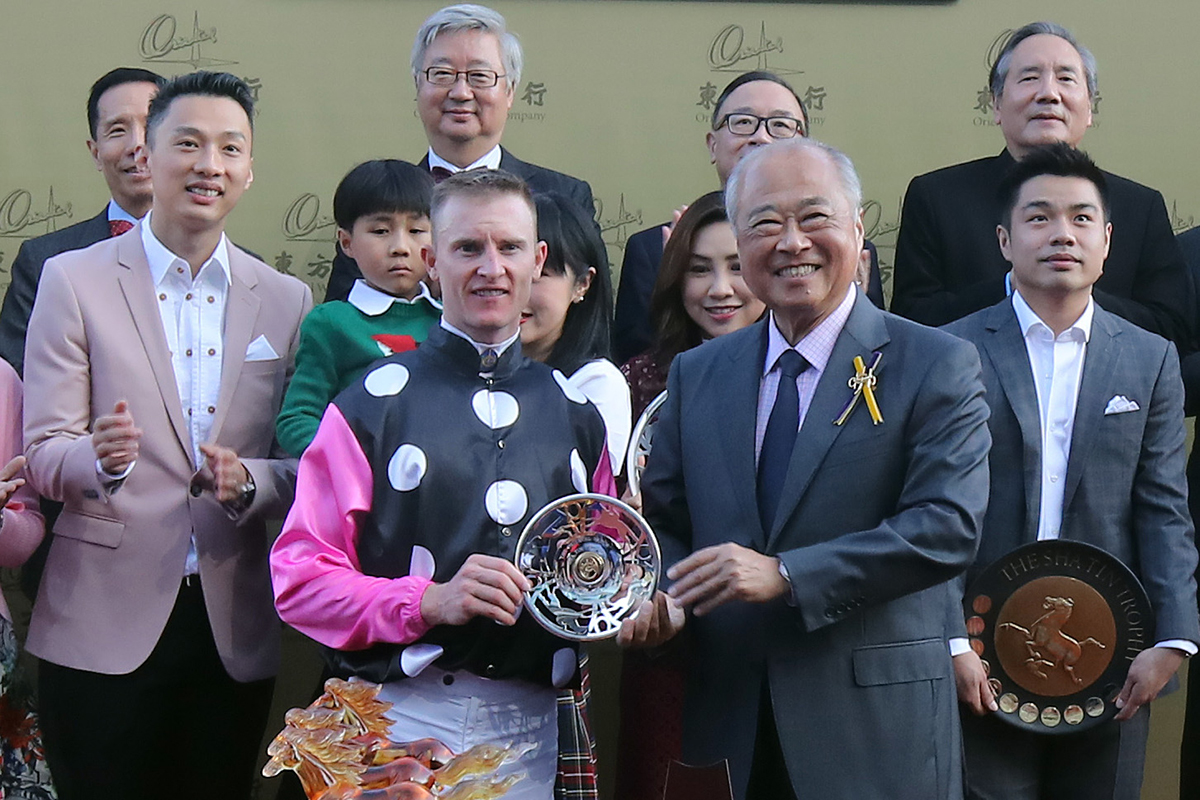 The Hon. Sir C K Chow, Steward of the Hong Kong Jockey Club, presents the trophy and silver dish each to owner Patrick Kwok and family, trainer John Moore and jockey Zac Purton, winning connections of Beauty Generation.