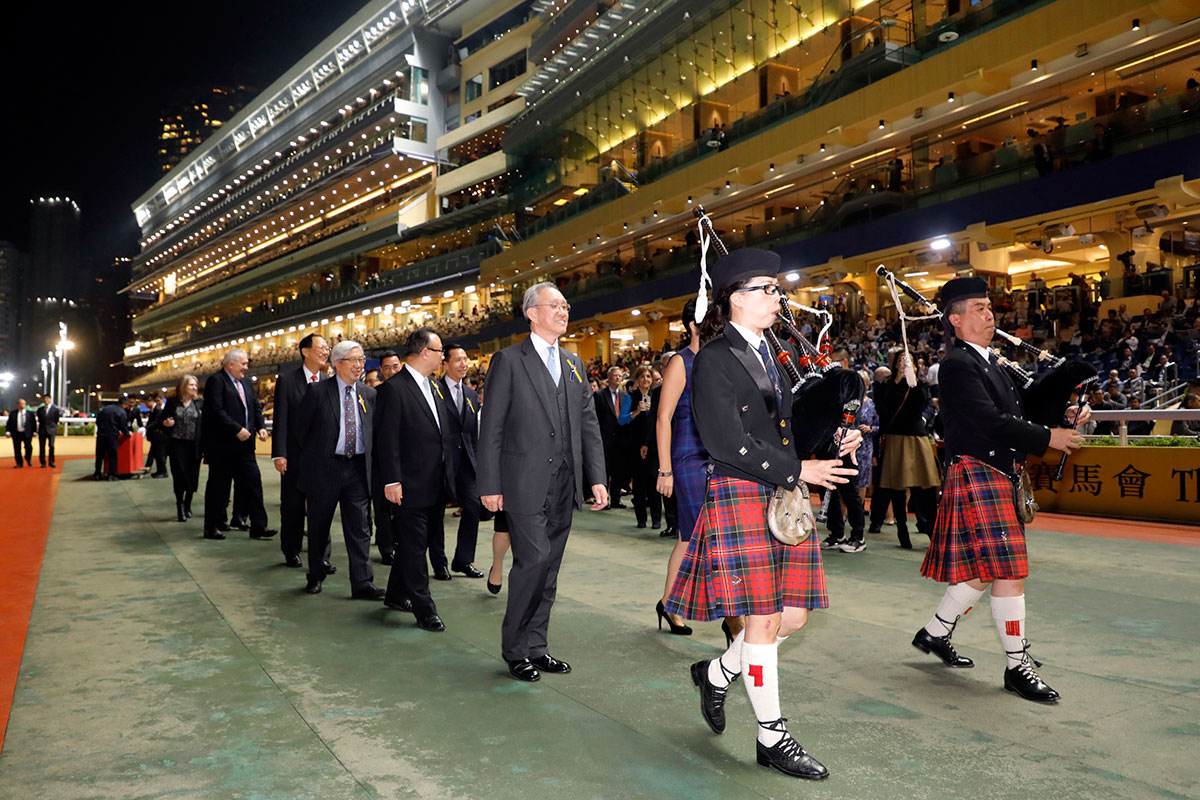 Pipers lead the procession after the night’s feature.