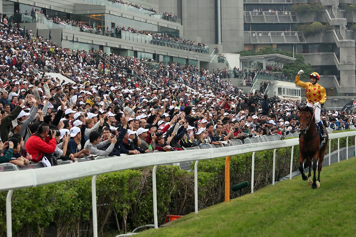 The Sha Tin crowd cheers Whyte after winning the Hong Kong Cup atop Akeed Mofeed.