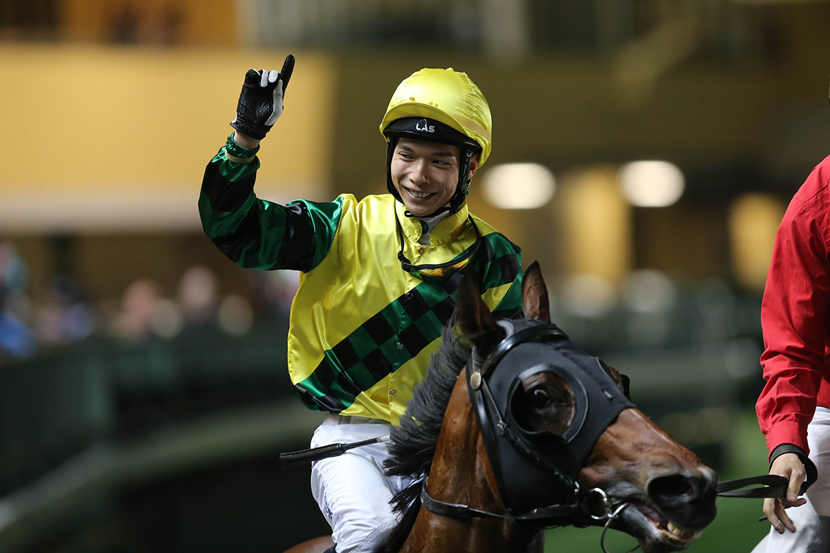 Victor Wong celebrating his win aboard Moment Of Power