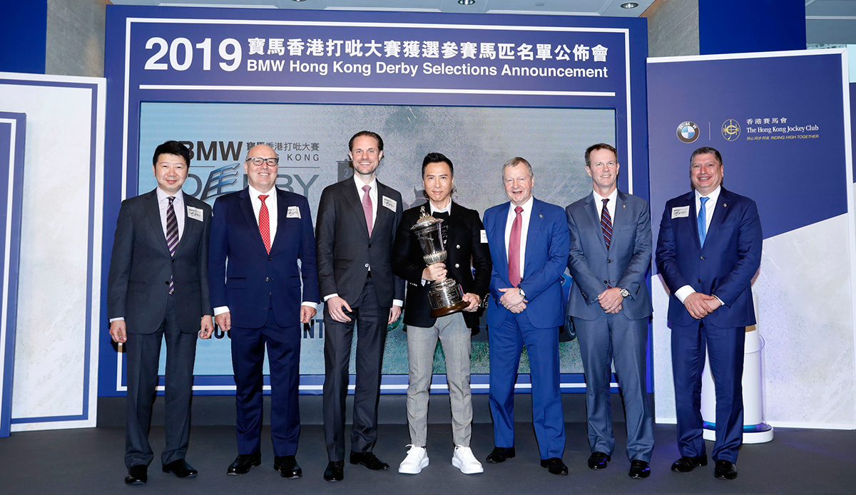 The Club’s and BMW’s senior officials, and Derby Ambassador Donnie Yen, pose with the BMW Hong Kong Derby trophy. From right: Mr. William A Nader, Director of Racing Business and Operations, HKJC, Mr. Andrew Harding, Executive Director, Racing, HKJC, Mr. Winfried Engelbrecht-Bresges, Chief Executive Officer, HKJC, Derby Ambassador Donnie Yen, Mr. Martijn Oremus, Managing Director, BMW Hong Kong Services Limited, Mr. Kevin Coon, Managing Director, BMW Hong Kong Services Limited and Mr. Joseph Lau, Managing Director, Hong Kong & Macau, BMW Concessionaires (HK) Limited