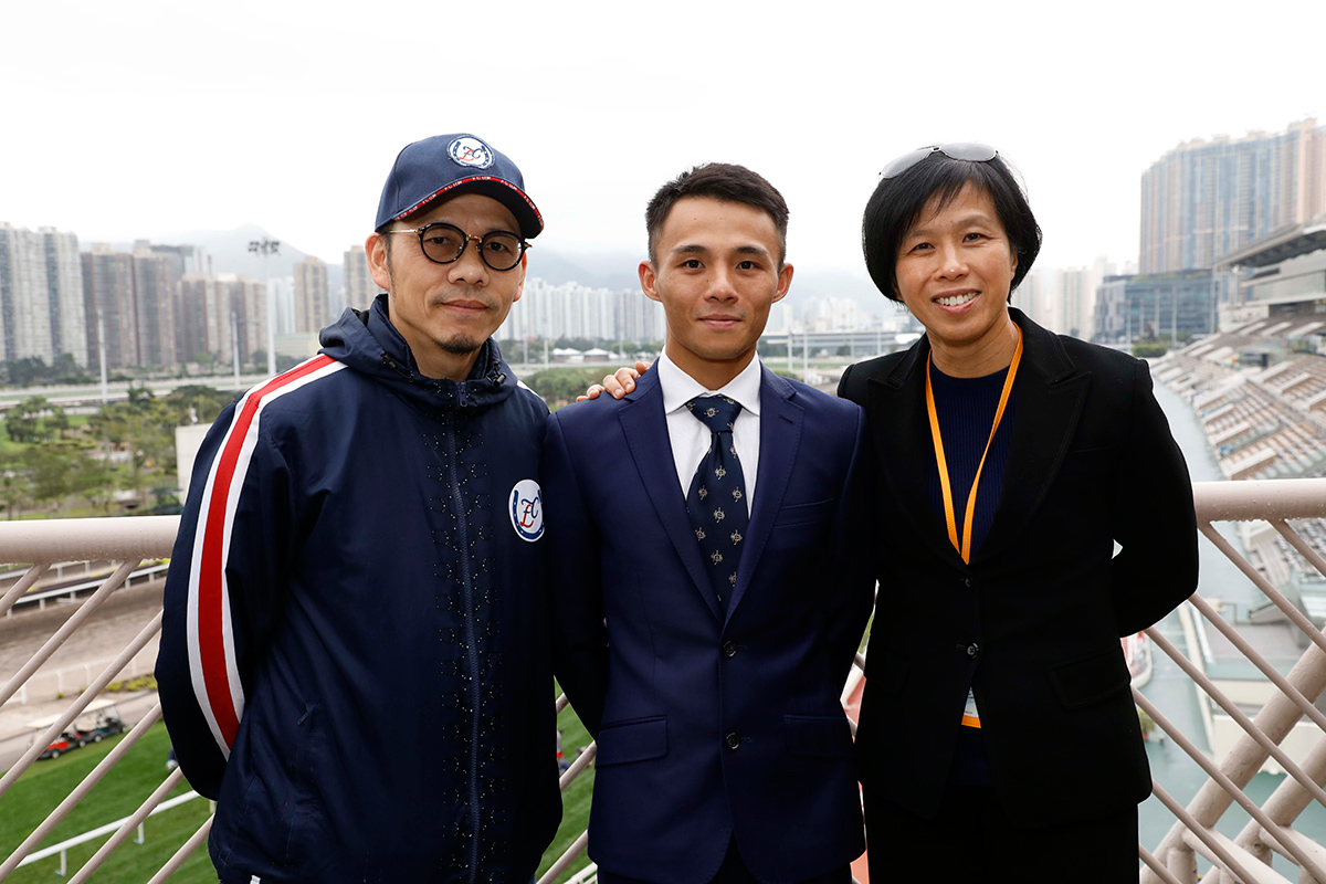Frankie Lor and Amy Chan pose with Alfred Chan after he was granted his license.