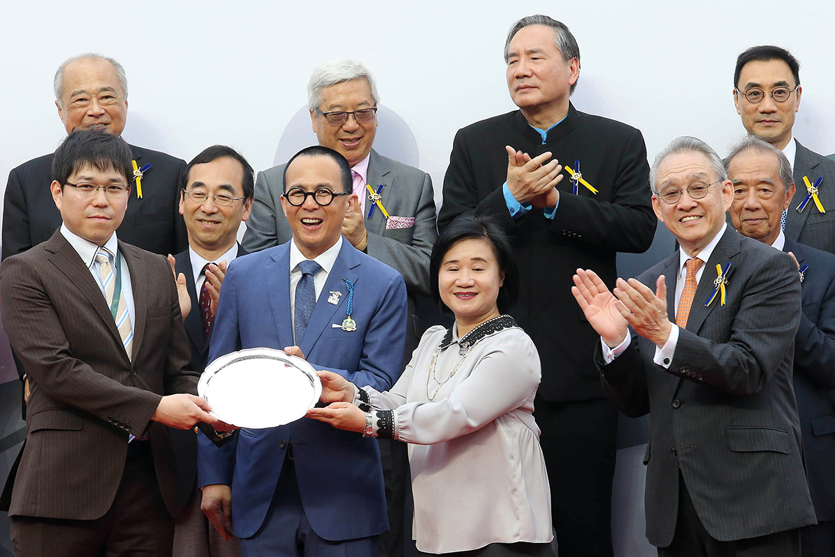 Mr Richard Li (center), Chairman and Chief Executive, Pacific Century Group, and Ms Nancy Chan (second from right), Chief Executive, Bank of Communications (Hong Kong) Limited, present a souvenir to the winning owner representative for FWD QEII Cup winner Win Bright.