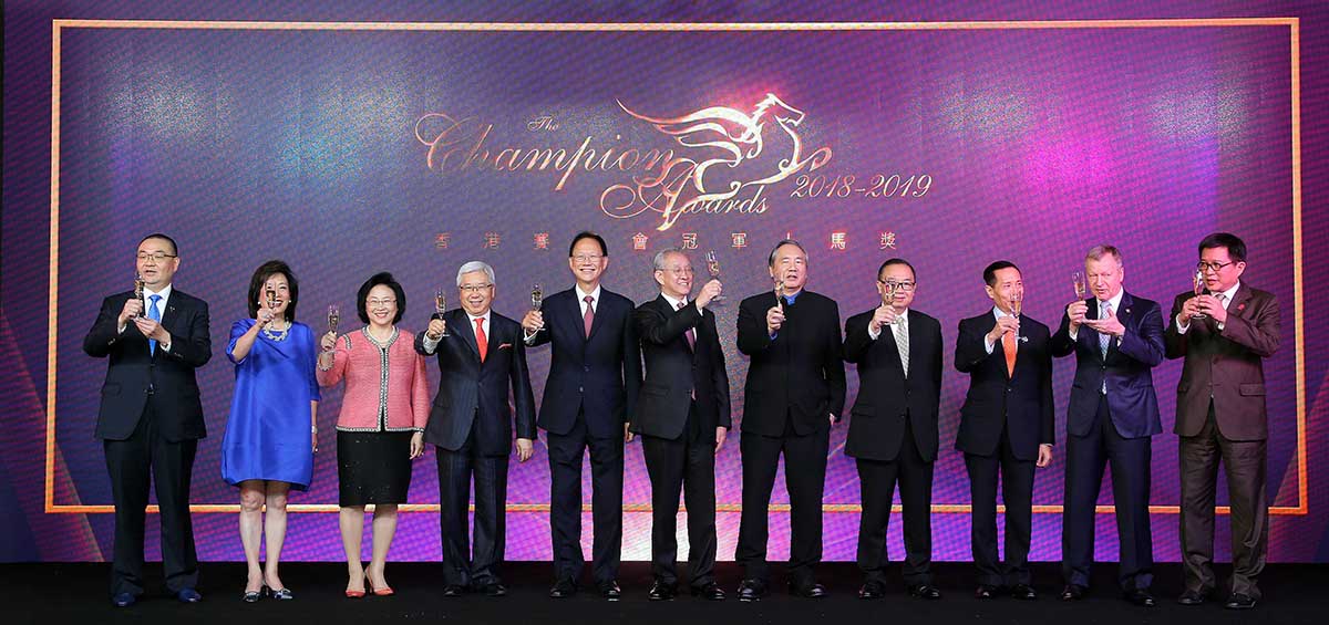 Officiating guests share a champagne toast to kick off the Champion Awards presentation ceremony for the 2018/19 racing season. From left: Mr. Benson Lo, President of the Hong Kong Racehorse Owners Association Dr. Rosanna Wong Yick Ming, Steward of The Hong Kong Jockey Club Mrs. Margaret Leung, Steward of The Hong Kong Jockey Club Dr. Eric Li Ka Cheung, Steward of The Hong Kong Jockey Club Mr. Philip N L Chen, Steward of The Hong Kong Jockey Club Dr. Anthony W K Chow, Chairman of The Hong Kong Jockey Club Mr. Stephen Ip Shu Kwan, Steward of The Hong Kong Jockey Club The Hon. Martin Liao, Steward of The Hong Kong Jockey Club Mr. Richard Tang Yat Sun, Steward of The Hong Kong Jockey Club Mr. Winfried Engelbrecht-Bresges, CEO of The Hong Kong Jockey Club Mr. Carlos Wu, Chairman of the Association of Hong Kong Racing Journalists