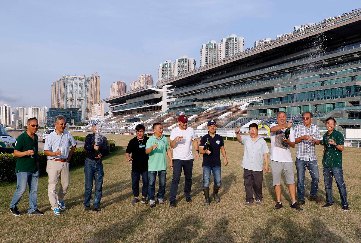 Club officials and trainers join the champagne toast at Sha Tin Racecourse.