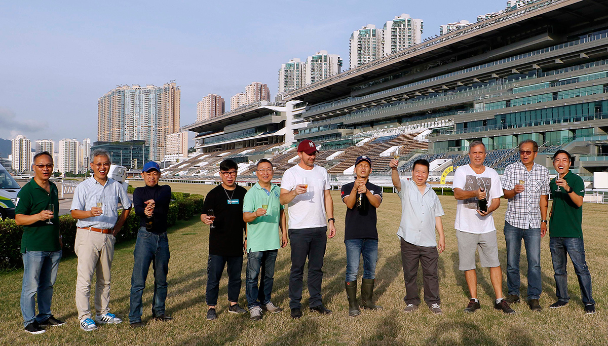 Club officials and trainers join the champagne toast at Sha Tin Racecourse.