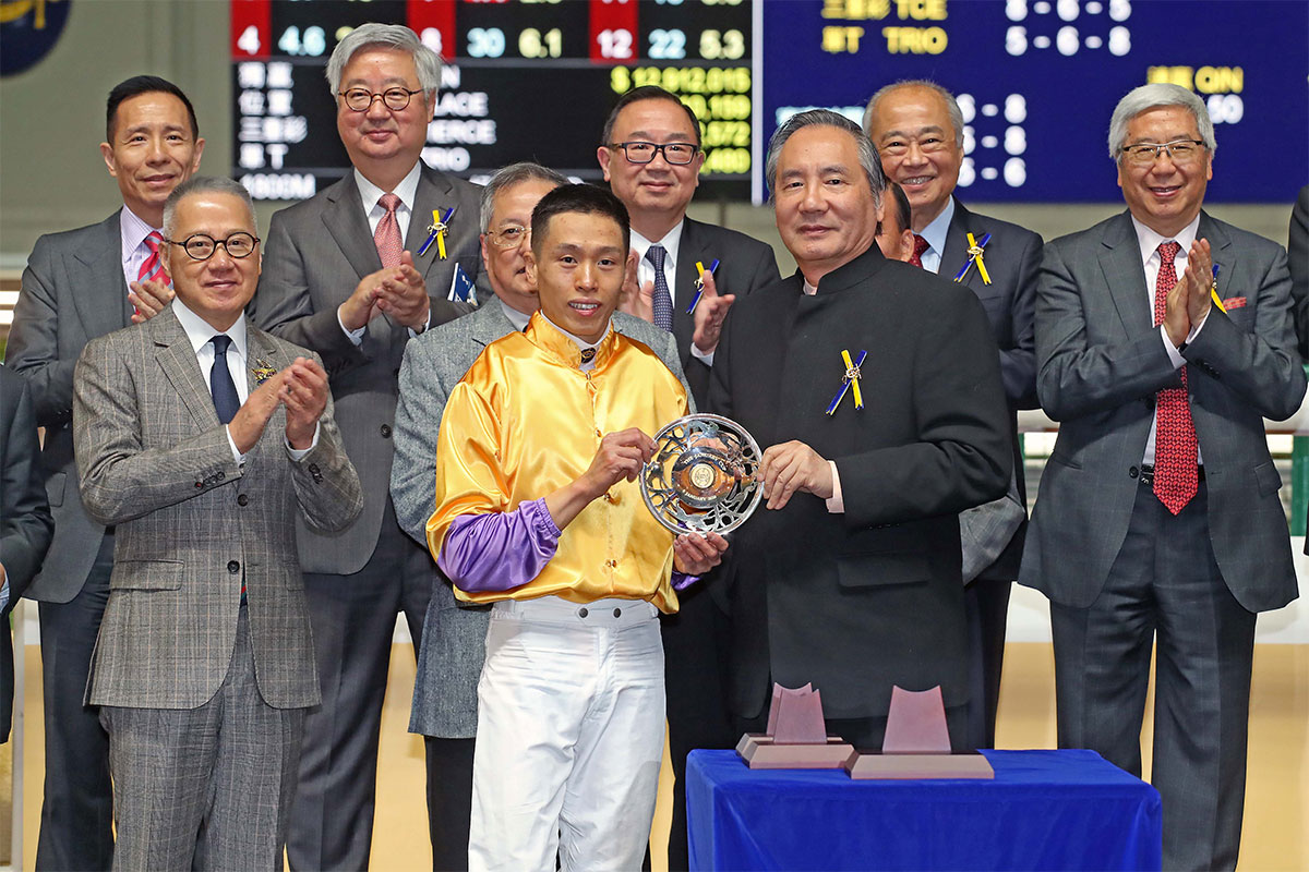 Mr Stephen Ip Shu Kwan, Steward of the Club, presents silver dishes to trainer Francis Lui and jockey Vincent Ho.