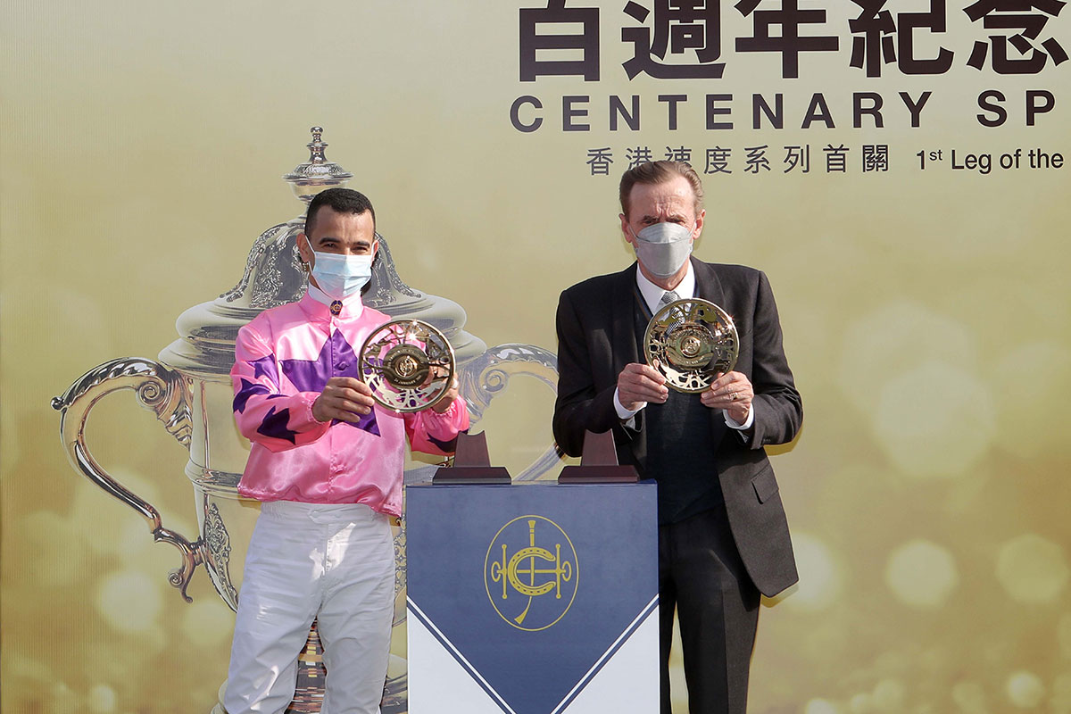 Winning trainer John Size (right) and jockey Joao Moreira (left) each receive their gold-plated dishes.