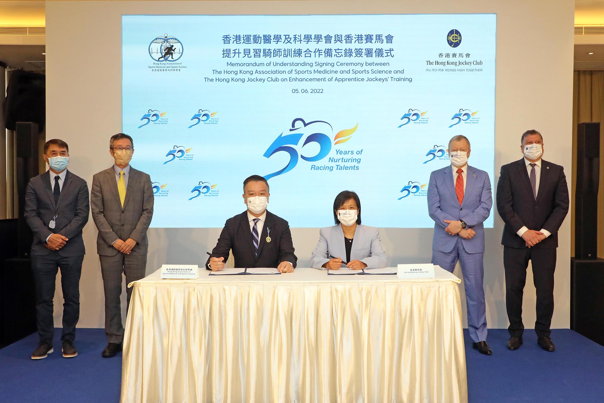 In the presence of Club Chief Executive Officer Winfried Engelbrecht-Bresges (back row, second right); Club Director of Racing Product, Marketing and Sponsorship William Nader (back row, first right); The Chinese University of Hong Kong Medical Centre Executive Director and Chief Executive Officer Prof. Fung Hong (back row, second left) and The Hong Kong Association of Sports Medicine and Sports Science (HKASMSS) Advisory board member Dr. Gary Mak (back row, first left), Club’s Racing Talent Training Centre Executive Manager and Headmistress of Apprentice Jockeys’ School Amy Chan (front row, right) signs the Memorandum of Understanding on Enhancement of Apprentice Jockeys’ Training with HKASMSS President Prof. Patrick Yung (front row, left).