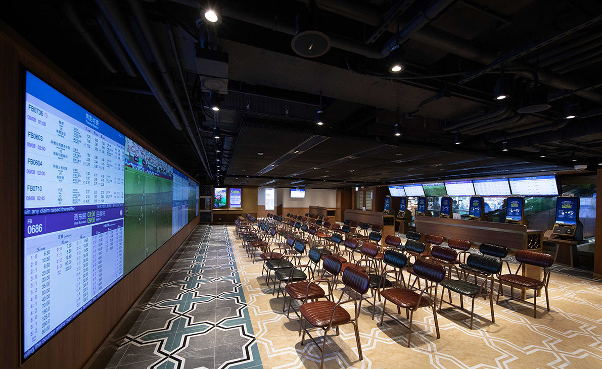 The betting and media hall is equipped with multiple large high-definition television screens.